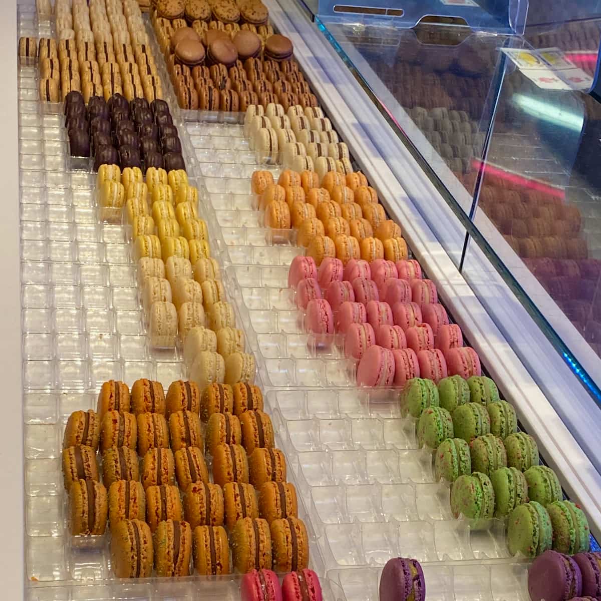 IMG_8860 rows of colourful macarons in window